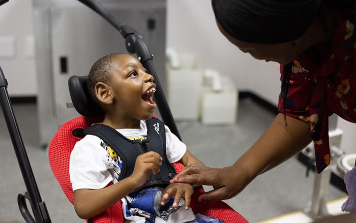 Doctor examining child with Cerebral Palsy