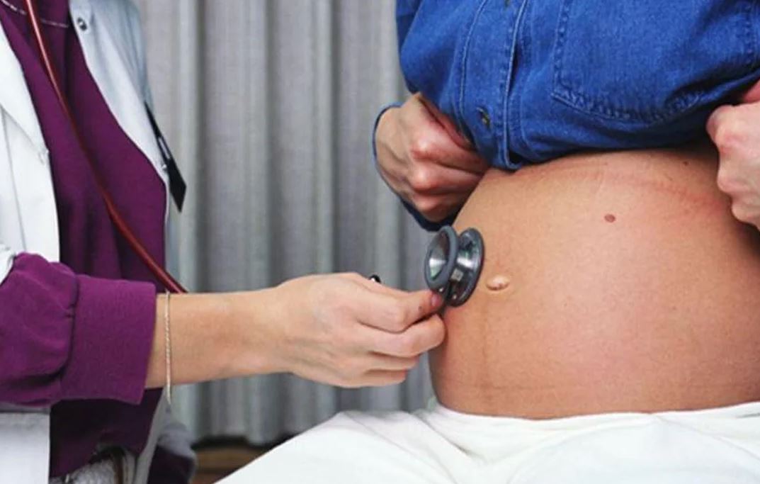 doctor examining pregnant woman