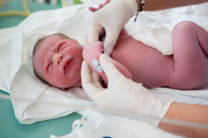 Baby being checked by doctor